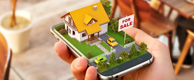 foto de uma casa em miniatura, sobre um celular